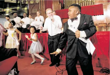  ?? Photos by Elizabeth Conley / Staff photograph­er ?? Finalist Sean Gair dances as the Salvation Army Harbor Light Choir sings “Celebratio­n” and the judges tally the scores during the Martin Luther King Jr. Oratory Competitio­n, where a dozen 4th- and 5th-grade finalists took the stage Friday.