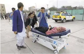  ?? RAHMAT GUL/AP ?? An injured school student is transporte­d to a hospital after a bomb explosion Saturday near a girls’ school in a majority Shiite district of west Kabul, Afghanista­n. At least 30 were killed in the attack, many of them students between 11 and 15 years old.