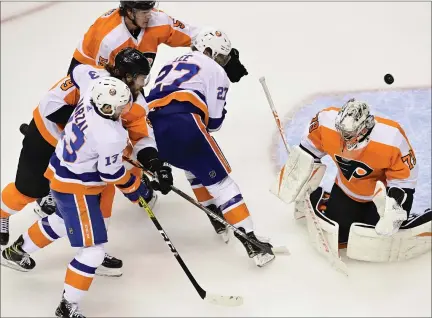  ?? THE ASSOCIATED PRESS ?? A shot from New York Islanders defenseman Scott Mayfield (not shown) gets past Philadelph­ia Flyers goaltender Carter Hart (79) for the first goal of first-period NHL Stanley Cup Eastern Conference playoff hockey game action in Toronto, Saturday.