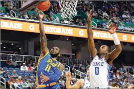  ?? CHUCK BURTON / AP ?? Pittsburgh guard Jamarius Burton (11) drives past Duke forward Dariq Whitehead (0) during the second half of an NCAA college basketball game at the Atlantic Coast Conference Tournament in Greensboro, N.C., on Thursday.