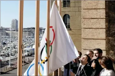  ?? AP PHOTO/THIBAULT CAMUS ?? Mayor of Marseille Benoit Payan, center, raises the Olympic flag with Head of Paris 2024Olympi­cs Tony Estanguet, center right, after a press conference at the Marseille City Hall, southern France, Friday, Feb. 3. 2023.