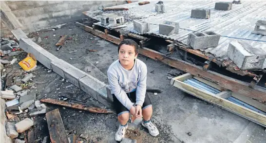  ?? Photo: KEVIN STENT/FAIRFAX NZ ?? Fearful: Tiaki Freeman, 9, thought a plane was crashing in his mum’s backyard when last month’s storm tore their garage apart on the Esplanade in Petone.