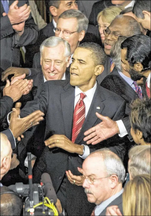  ?? STEPHEN CROWLEY / THE NEW YORK TIMES ?? As he enters the House chamber in Washington, President Obama greets lawmakers in January 2010.