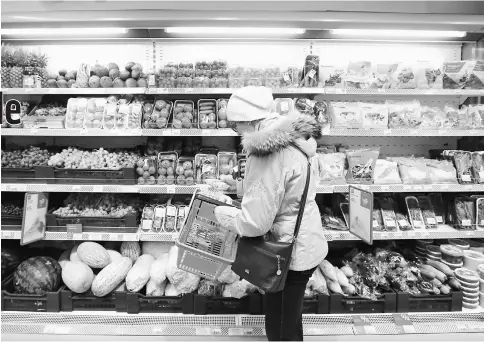  ??  ?? A customer browses fruit and vegetable products inside a Victoria supermarke­t in Moscow on Oct 21, 2016. — WP-Bloomberg photo