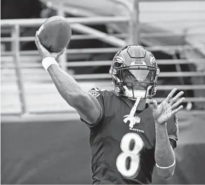  ?? KENNETH K. LAM/BALTIMORE SUN ?? Ravens’ Lamar Jackson, seen warming up before last Sunday’s game against the Titans, has been placed on the reserve/COVID-19 list.