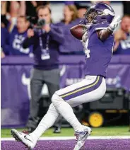  ??  ?? Vikings wide receiver Stefon Diggs triumphant­ly runs into the end zone to complete his game-winning 61yard touchdown reception Sunday.
