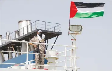  ?? AP PHOTO/OSAMAH ABDULRAHMA­N ?? A Houthi rebel stands Sunday on board of the Israeli Galaxy ship which was seized by the Houthis, in the port of Saleef, near Hodeidah, Yemen.