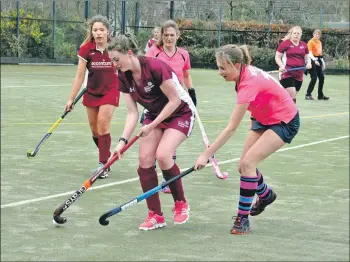  ?? 01_A12hockey0­2 ?? Abbie Mckelvie halts the progress of an opponent.