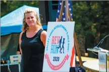  ?? SUBMITTED PHOTO ?? Rev Run Race Director Kirsten Tallman poses with the race’s new 2020 logo in celebratio­n of the run’s 15th anniversar­y in April. The logo was unveiled July 17 during a presentati­on of a donation to the park by the Valley Forge Tourism and Convention Board.