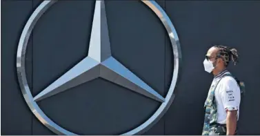  ??  ?? Hamilton camino delante de un gran emblema de Mercedes-Benz durante el pasado GP de España.