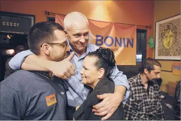  ?? Gary Friedman
Los Angeles Times ?? MIKE BONIN IS JOINED BY SEAN ARIAN, left, and Dela Jimenez after declaring victory Tuesday. He is among the council candidates backed by union groups such as the county Federation of Labor.
