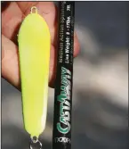  ?? Arkansas Democrat-Gazette/BRYAN HENDRICKS ?? uses a large supply of 2-ounce spoons to tame Lake DeGray’s big hybrids. The lures demand stout tackle and heavy line.