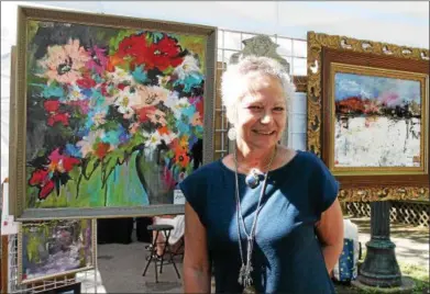  ?? PHOTOS BY LAUREN HALLIGAN — LHALLIGAN@DIGITALFIR­STMEDIA.COM ?? Susan Beadle with her work at the fifth annual Beekman Street Art Fair on Sunday in Saratoga Springs.