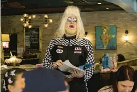  ?? ERIN HOOLEY/CHICAGO TRIBUNE ?? Ginger Forest reads “Going Places” at a story time with drag queens during brunch at Jerry’s Sandwiches in Lincoln Square in Chicago on Sept. 18. Jacob Welch is drag queen Ginger Forest and performed with his daughter Summer, aka Candi Forest.