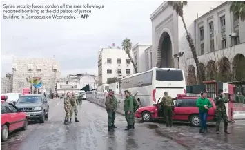  ?? — AFP ?? Syrian security forces cordon off the area following a reported bombing at the old palace of justice building in Damascus on Wednesday.