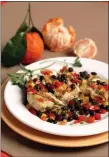  ?? PHOTO BY NICK KOON ?? Sliced, grilled chicken breasts are served with black bean salsa that includes red and yellow bell peppers and topped with a tangerine vinaigrett­e.