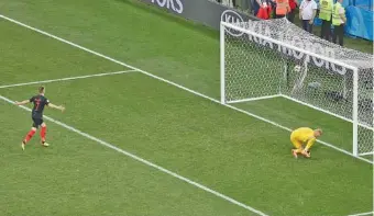  ?? THE ASSOCIATED PRESS ?? Denmark goalkeeper Kasper Schmeichel, right, is unable to stop a penalty kick by Croatia’s Ivan Rakitic during a shootout to decide their World Cup round-of-16 match Sunday in Nizhny Novgorod, Russia. Denmark advanced to the quarterfin­als by winning...