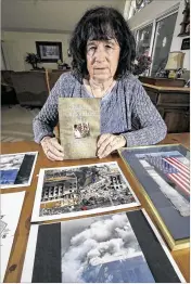  ?? BRUCE ACKERMAN / STAR-BANNER ?? Janet Horton sits with pictures of the Pentagon from the 9/11 attack and her book titled “Cracking The Camouflfla­ge Ceiling” at her home in Ocala.