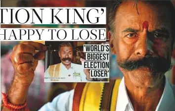  ?? AFP ?? K. Padmarajan shows a photograph featuring himself stating ‘World’s Biggest Election Loser’ at his office in Mettur, near Salem district in India’s Tamil Nadu state.