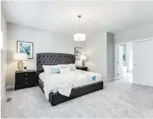  ??  ?? The top level of this Killarney townhome features a large master bedroom.
