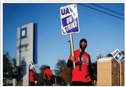  ?? AP/PAUL SANCYA ?? A member of the United Auto Workers walks the picket line last week at a General Motors plant in Romulus, Mich. GM Co. Chief Executive Officer Mary Barra met Tuesday with strike leaders at the bargaining table in Detroit.