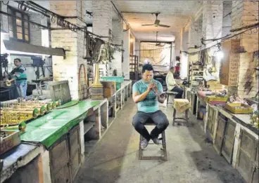  ?? SANCHIT KHANNA/ HT ?? Noor Alam tests a trumpet at Nadir Ali & Co, India’s biggest wind instrument makers in Meerut.