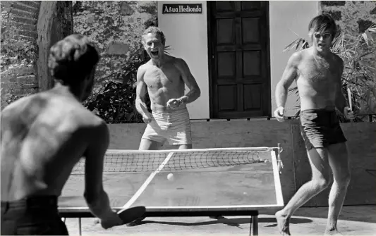  ??  ?? Paul Newman, centre, and Robert Redford, right, team up in a table tennis doubles match on the set of Butch Cassidy and the Sundance Kid, Durango, Mexico, 1968