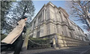  ?? BLOOMBERG ?? A pedestrian walks past Bank of Japan (BOJ) headquarte­rs in Tokyo, Japan.