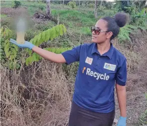  ?? ?? A Waste Recyclers Fiji Limited staff with urine-filled bottle during the clean-up.