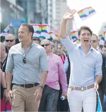  ?? GRAHAM HUGHES / THE CANADIAN PRESS ?? Prime Minister Justin Trudeau and Irish leader Leo Varadkar march in Montreal’s Pride parade pride on Sunday, as violence broke out at an anti-immigratio­n rally in Quebec City. The PM condemned the “racist demonstrat­ions.”