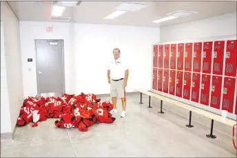  ?? PHOTOS BY MARK HUMPHREY ENTERPRISE-LEADER ?? Farmington defensive coordinato­r Jay Harper and other members of the football coaching staff took fans on guided tours of the brand new $16 million Farmington Sports Complex during grand opening on Thursday, Aug. 15, 2019. This is a track and field locker room, which was being used by junior high football players that day.