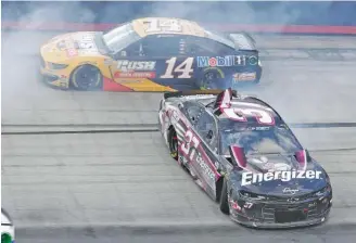  ?? AP PHOTO/MARK HUMPHREY ?? Clint Bowyer (14) drives past Ryan Preece as he spins after a crash during the NASCAR All-Star Open on July 15 Bristol Motor Speedway in Tennessee. The Cup Series races tonight at Kansas Speedway.