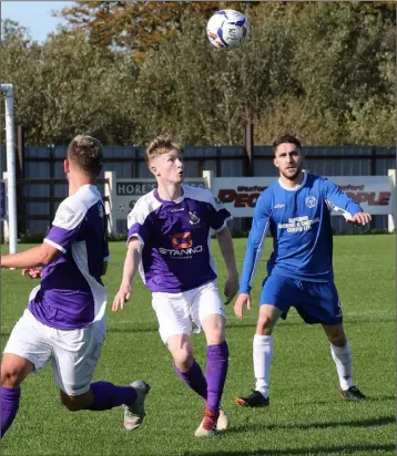  ??  ?? Conor Casserly of the Wexford Football League keeps his eyes on the ball as Jordan Buckley closes in.