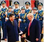  ?? ARTYOM IVANOV /TASS 2017 ?? Chinese President Xi Jinping and U.S. President Donald Trump shake hands in 2017 during a meeting in Beijing.