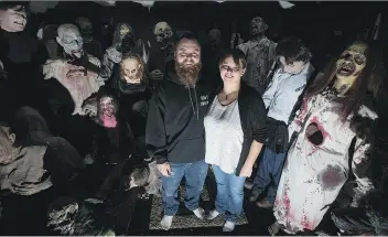  ?? KAYLE NEIS ?? Adam Krutko, left, and Lyndsey Fernets are surrounded by props that are used for their popular haunted house event. A noise complaint was filed with police last month about the Halloween tradition.