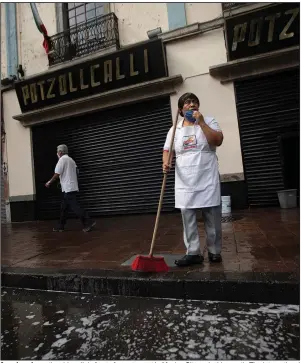  ?? (AP/Fernando Llano) ?? A worker cleans the sidewalk in front of a restaurant in Mexico City early this month. The Internatio­nal Monetary Fund is forecastin­g a nearly double-digit recession for Latin America and the Caribbean this year. Video is available at arkansason­line.com/625fund/.