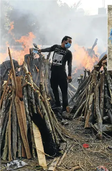  ?? Picture: Adnan Abidi/Reuters ?? A man performs last rites next to the funeral pyres of people who died from Covid-19, during a mass cremation in New Delhi, India. The country experience­d its deadliest day on Thursday this week, when 3,645 people died from the disease.