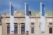  ?? ASSOCIATED PRESS FILE PHOTO ?? Flags wave in the wind in front of the entrance of the Permanent Council of the Organizati­on for Security and Cooperatio­n in Europe, OSCE, in Vienna, Austria, in 2022.