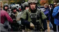  ?? Jeff Swensen/Washington Post ?? SWAT team members leave the scene of a mass shooting at the Tree of Life Synagogue in Pittsburgh.