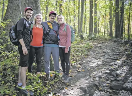  ?? BY BEN PETERS ?? A group of friends including Dan Elliot of Washington D.C., Elizabeth Markey of Richmond, and Jessie Longo and Julie Elliot both of New York City, pose for a photo as they make their way to Old Rag’s base last week.