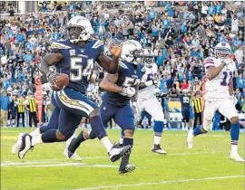  ?? Wally Skalij Los Angeles Times ?? MELVIN INGRAM of the Chargers heads for the end zone after picking up a fumble by Buffalo’s Tyrod Taylor. It was the Bills’ sixth turnover of the game.