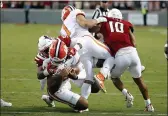  ?? KARL B DEBLAKER — THE ASSOCIATED PRESS ?? North Carolina State’s Savion Jackson (90) tackles Clemson’s D.J. Uiagalelei (5) as the left leg of Clemson running back Will Shipley (1) gets caught with North Carolina State’s Tanner Ingle (10) also defending during the second half Saturday in Raleigh, N.C.