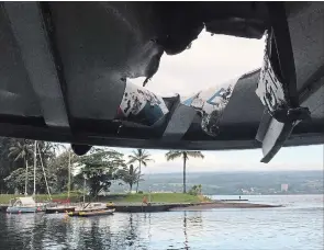  ?? THE ASSOCIATED PRESS ?? This photo provided by the Hawaii Department of Land and Natural Resources shows damage to the roof of a tour boat after an explosion sent lava flying through the roof.