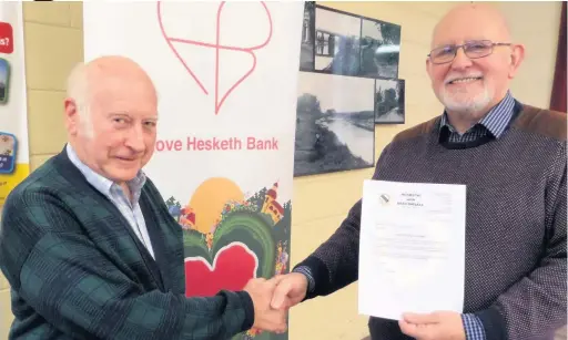  ??  ?? Parish councillor Ron Tyson, left, and Mike Ellis,of Hesketh Bank Community Centre with the letter confirming the grant