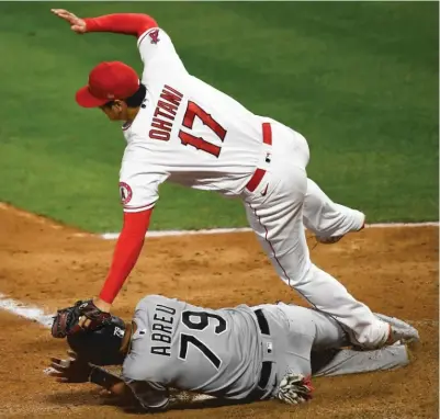  ?? GETTY IMAGES ?? Jose Abreu slides into Angels pitcher Shohei Ohtani in the fifth inning. Ohtani was shaken up on the play.