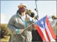  ?? Brian A. Pounds / Hearst Connecticu­t Media ?? Ilsa Nieves, of Meriden, holds a Puerto Rican flag as she supports Secretary of Education Miguel Cardona and first lady Jill Biden outside Benjamin Franklin School in Meriden on Wednesday.