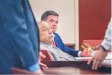  ?? EDDIE MOORE/JOURNAL ?? Former state Sen. Phil Griego, left, with one of his attorneys, Elden Pennington, watches retired Secretary of Energy Minerals and Natural Resources David Martin walk to the witness stand during the corruption trial of Griego on Thursday in Santa Fe.