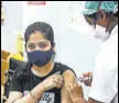  ?? PTI ?? A woman receives a Covid-19 vaccine dose in Mumbai.