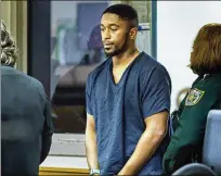  ?? LANNIS WATERS / THE PALM BEACH POST ?? Taraus McKinley enters a courtroom Monday at the Palm Beach County Jail. He’s accused of shooting fellow Pahokee resident Anthony Martin to death Sunday.