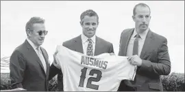  ?? Myung J. Chun Los Angeles Times ?? BRAD AUSMUS, flanked by Angels owner Arte Moreno, left, and general manager Billy Eppler, had a 314-332 record in four seasons as Detroit’s manager.